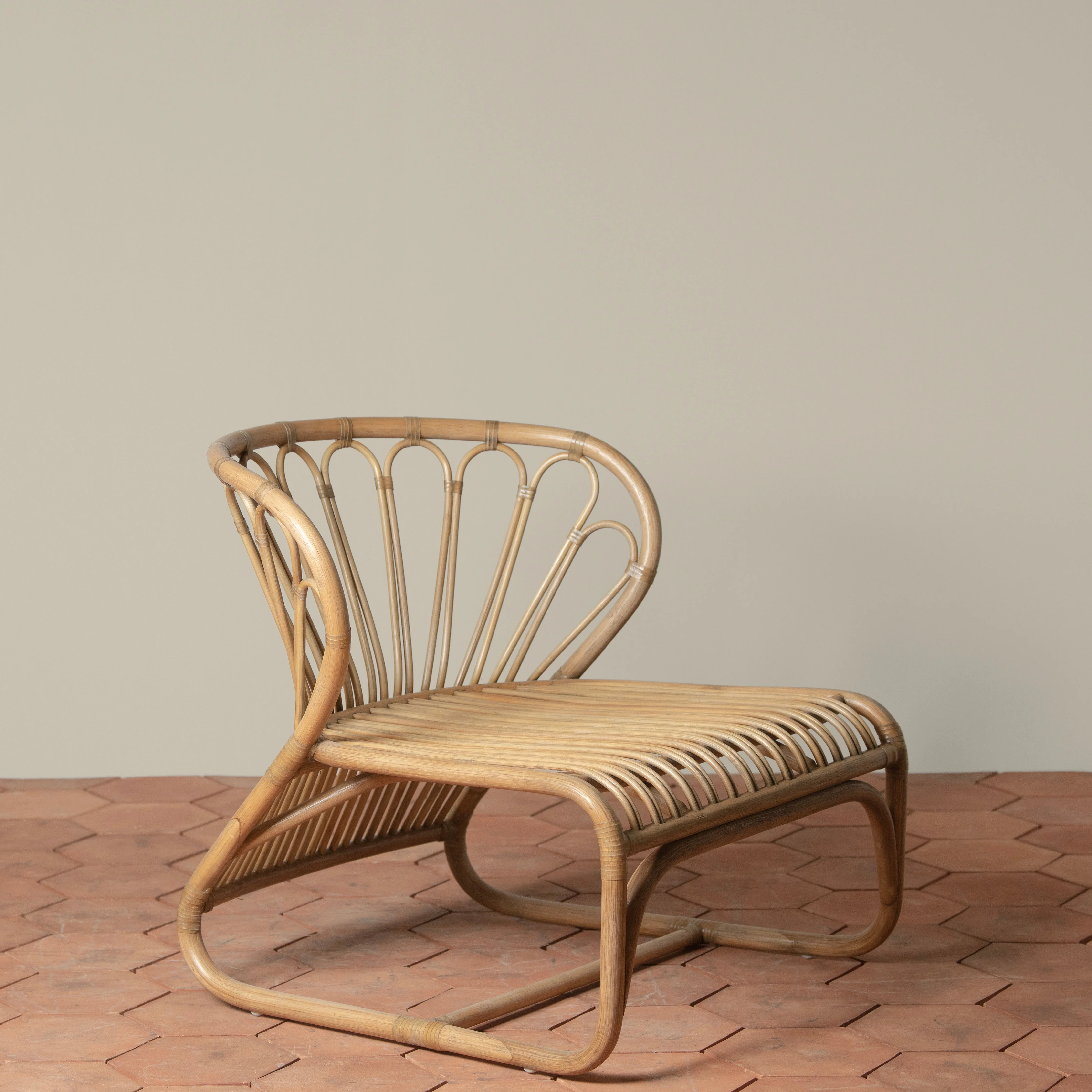 Low-Profile Handcrafted Indonesian Rattan & Belgian Linen Outdoor Lounge Chair with Rawhide Accents for Patio or Garden