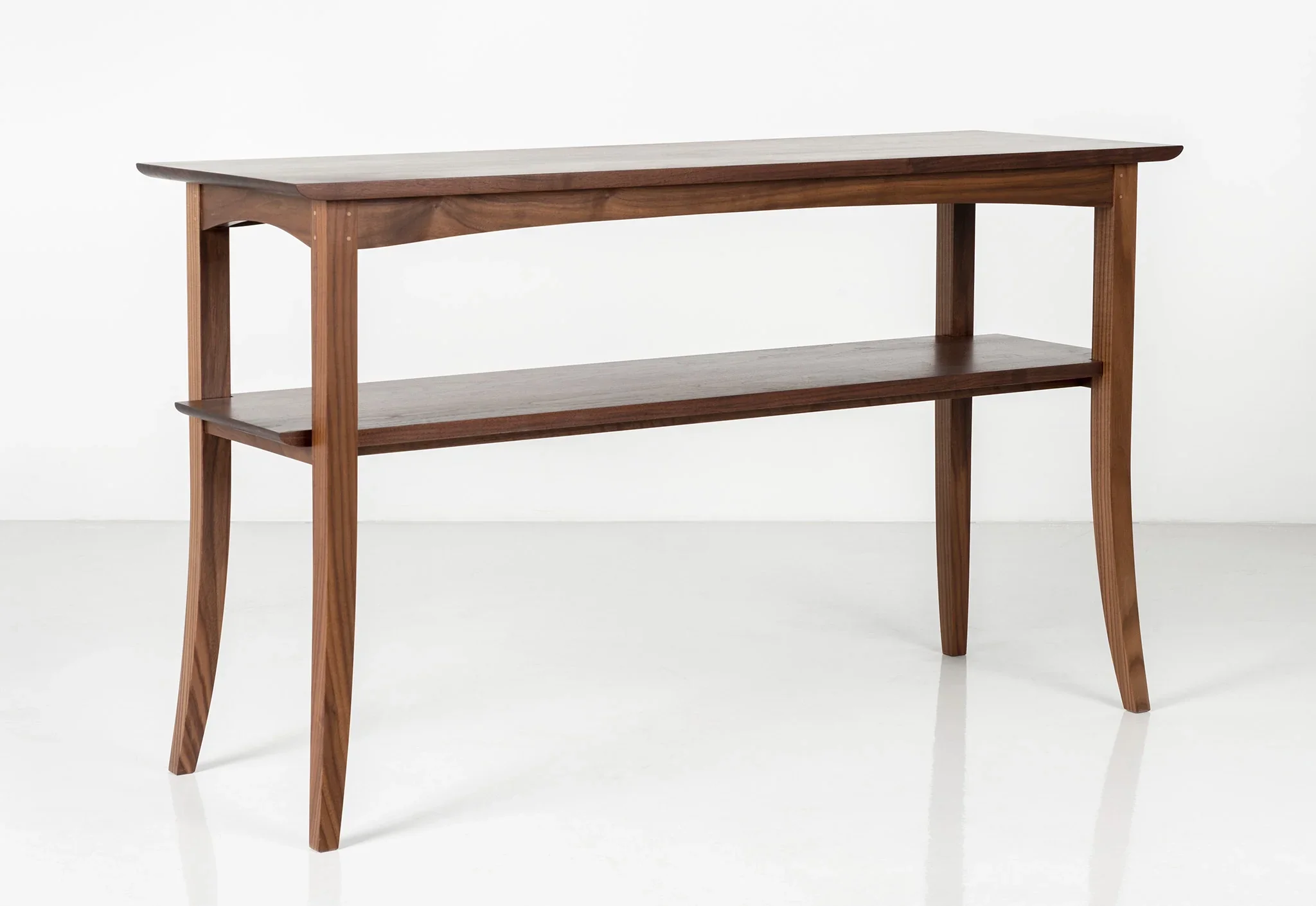 Hall Table - Ideal for narrow spaces or situated along a wall, the has sweeping legs and a simple, notched shelf