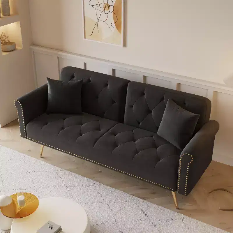 Black Velvet Fabric Sofa Featuring Nail Head Trim and Accompanied By A Matching Throw Pillow