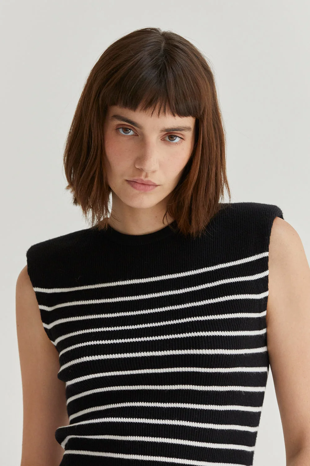 Ribbed Stripe Sleeveless Knit Top with Padded Shoulders and Side Slits