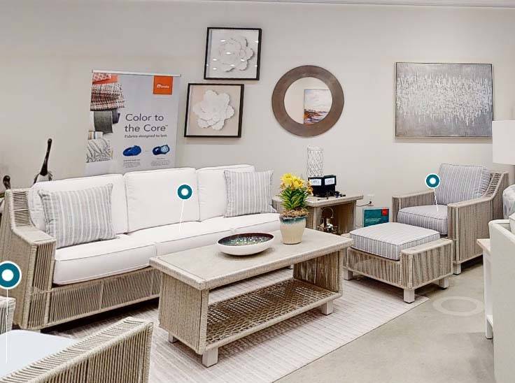Luxe Outdoor Wicker Sofa with White Cushions and Striped Accent Pillows