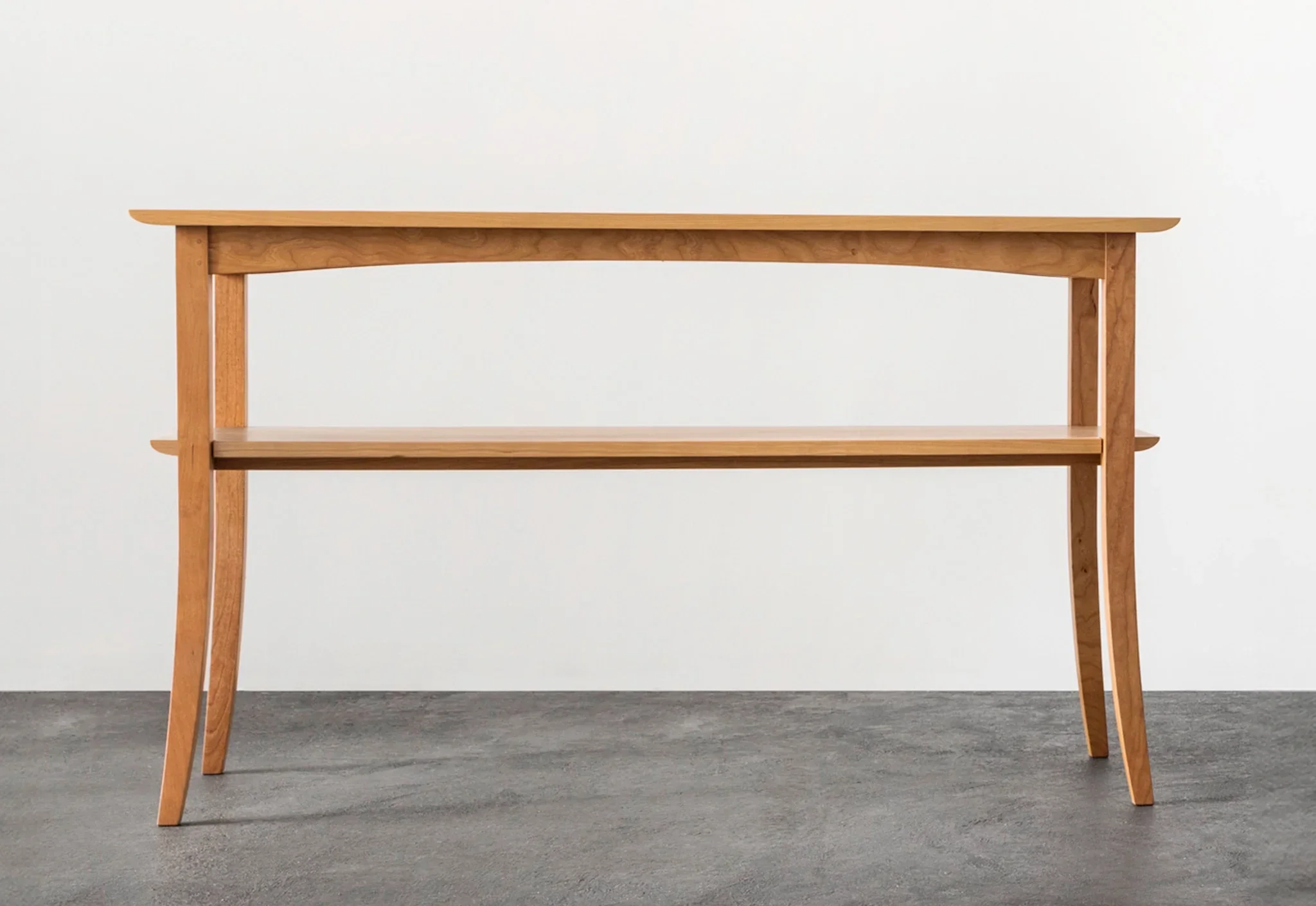 Hall Table - Ideal for narrow spaces or situated along a wall, the has sweeping legs and a simple, notched shelf